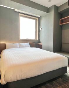 Postel nebo postele na pokoji v ubytování KIN HOTEL