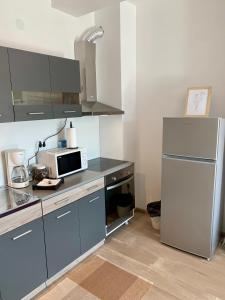 a kitchen with a microwave and a refrigerator at Apartman-Stefanovic in Vranje