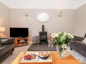 a living room with a table with a tray of food at Church View in Grange Over Sands