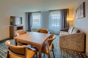 een woonkamer met een tafel en een bank bij Homewood Suites by Hilton South Bend Notre Dame Area in South Bend