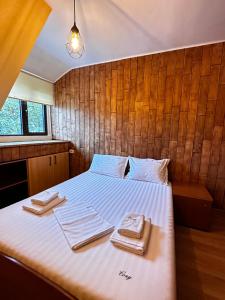 a bedroom with a bed with two towels on it at Cozy Apartments - Private Urban Living #Targu Mures in Târgu-Mureş