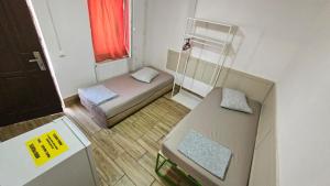 a small room with two beds and a window at Gara de Nord-Banat-4-You in Bucharest