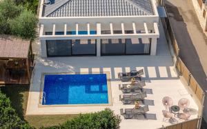 an aerial view of a house with a swimming pool at Oresteia Exclusive Villa, a Sublime Retreat, By ThinkVilla in Tragaki