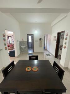 a dining room with a table with two donuts on it at Hrishi’s home in Guwahati