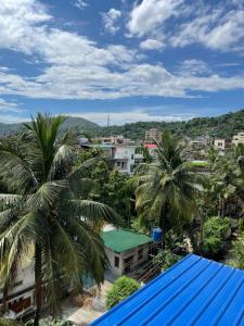 a view of a city with palm trees and buildings at Hrishi’s home in Guwahati