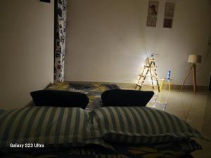 a bedroom with a bed and a tripod in a room at Hrishi’s home in Guwahati