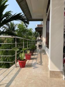 a balcony with potted plants on the side of a building at Hrishi’s home in Guwahati +4 photos