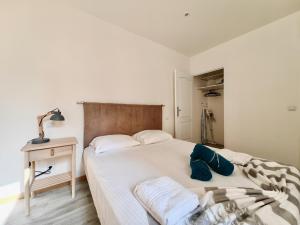 a bedroom with a bed and a table with a lamp at Foch 3 by Booking Guys in Villefranche-sur-Mer