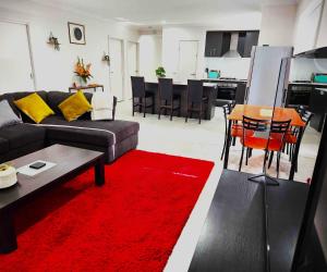 a living room with a couch and a red rug at Lucas One 2-bedroom apartment NBN Pets in Windermere