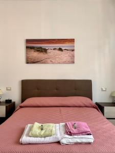 a bedroom with a bed with two towels on it at appartamento fronte mare in Falconara Marittima