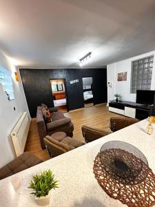 a living room with a couch and a table at Cozy Apartments - Private Urban Living #Targu Mures in Târgu-Mureş