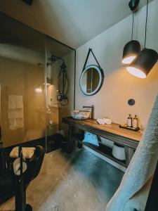 a bathroom with a wooden table and a mirror at TerraSense Mountain Charm Retreat & Farm in Videmonte