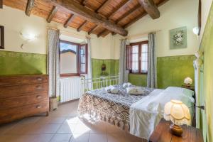a bedroom with a bed in a room with green walls at Vecchia Fornace La Piastra Agriturismo, with pool, Abetone in Pian degli Ontani +44 photos