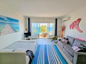 a living room with a couch and a living room with the ocean at Promenade Sea Front in Nice