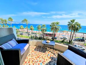 a balcony with a couch and a view of the ocean at Promenade Sea Front in Nice