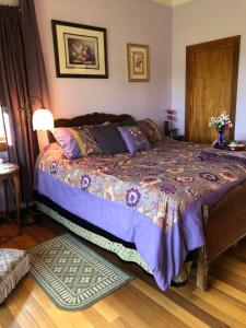 a bedroom with a bed with a purple comforter at Coppertoppe Inn & Retreat Center in Hebron