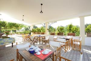 a patio with a table and chairs and a table and chairsktop at B&B Casale Spisari in Galatone