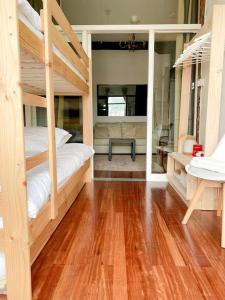 a bedroom with two bunk beds and a wooden floor at Refugio noruego in Bilbao