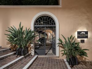 an entrance to a building with two plants in front of a door at Casa Delfino Hotel & Spa in Chania Town