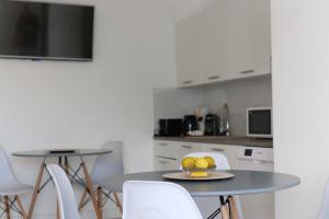 a kitchen with a table with a bowl of fruit on it at Prestige Miskolctapolca in Miskolctapolca
