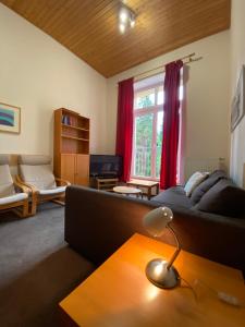 a living room with a couch and a table at Apartmány Poustevník Resort in Pec pod Sněžkou