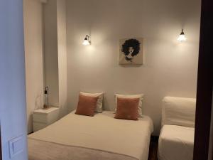 a room with two beds and a couch and lights at Miguel Bombarda Cozy Apartment in Porto