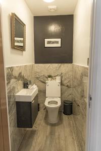 a bathroom with a toilet and a sink at Elms Cottage in Spalding