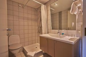 a bathroom with a sink and a toilet at Zleep Hotel Køge in Køge