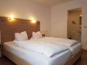 Postel nebo postele na pokoji v ubytování Hotel Mühleneck