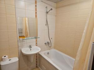 a bathroom with a sink and a tub and a toilet at Apartment in Borovets Gardens C17 in Borovets