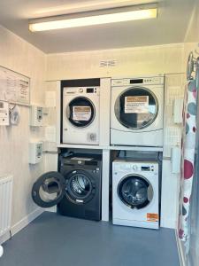 lavadero con 3 lavadoras y lavadora y secadora en 3 Bedroom Self Catering Static Caravan, en Steps