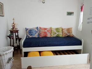 a bed with blue sheets and pillows in a room at La Terrazza Solarium in Santa Flavia