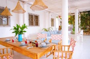 a living room with a wooden table and chairs at The Kilimanjaro Villa in Moshi