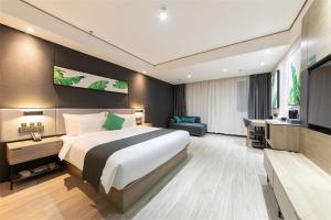 a hotel room with a large bed and a desk at Thank Inn Plus Suqian Shuyang Shandong Mall in Suqian