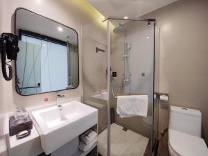 a bathroom with a sink and a shower and a toilet at Thank Inn Plus Lanzhou Dongfanghong Plaza Pingliang Road in Lanzhou