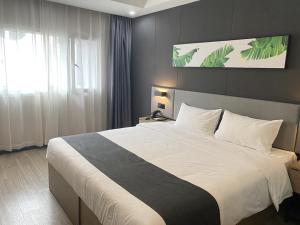Ліжко або ліжка в номері Thank Inn Plus Taian Dongping Xishan Road