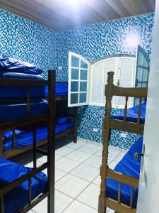 Katil atau katil-katil dalam bilik di Casa Temporada Bertioga