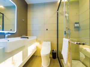 a bathroom with a toilet and a sink and a shower at Thank Inn Plus Datong Senyuan Building High-Speed Railway Station in Datong