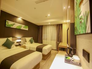 a hotel room with two beds and a television at Thank Inn Plus Beijing Yizhuang Maju Bridge Jinghai Road in Tongzhou