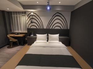 a bedroom with a large bed and a desk with a desk at Thank Inn Plus Lanzhou New District Zhongchuan Airport Rainbow City in Lanzhou