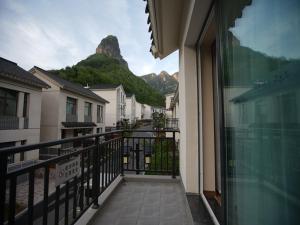 a balcony with a view of a mountain at Feronia Hotel Taihang Xiyagou Tourist Area in Nanhekou