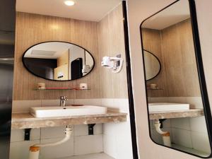 a bathroom with a sink and a mirror at Thank Inn Plus Kashgar Ancient City Pedestrian Street in Kashgar