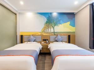 a room with three beds and a mural on the wall at Junyi Hotel Hefei South High-Speed Railway Station in Hefei