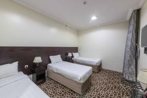 Postel nebo postele na pokoji v ubytování Abdul Hafez Al Humaidan Hotel