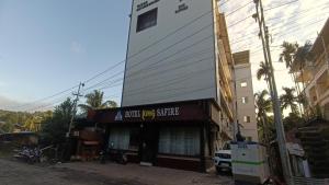 a building with a sign that reads a blood dog service at Hotel King Safire in Port Blair