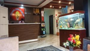 a woman standing at the counter of a fish shop at Hotel King Safire in Port Blair +46 photos