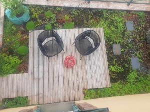 an overhead view of a wooden deck with a red flower at la maison haute in Toucy