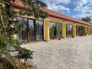 a building with a lot of windows on it at Vitál Guesthouse in Almamellék