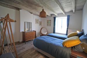 a bedroom with two beds and a ladder and a window at La cle des champs 