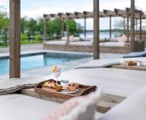 a tray of food on a table next to a swimming pool at Skytteholm in Ekerö